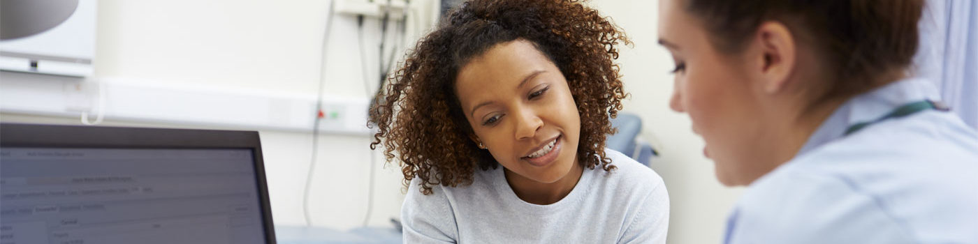 photo of a woman speaking to a health care specialist