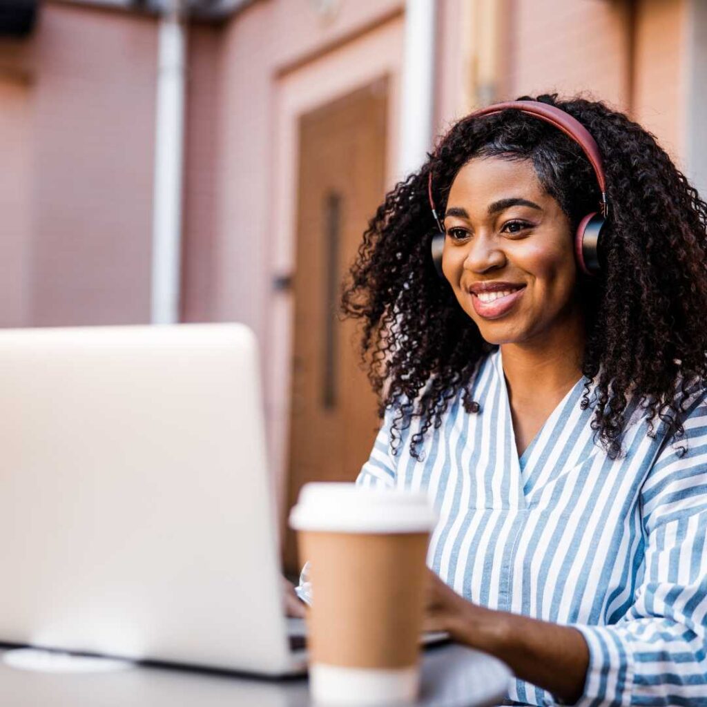 Woman smiling and typing into a computer