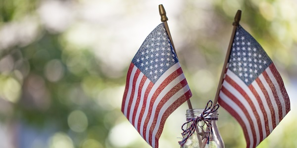 American flags with bokeh green background